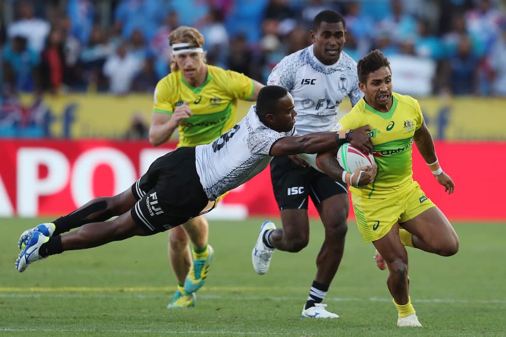 Maurice Longbottom evades a Fijian tackler on his way to a try. Photo: AFP