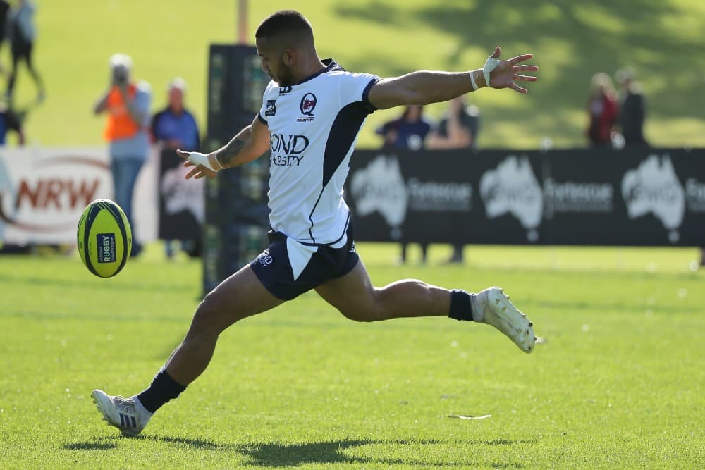 Queensland Country flyhalf Rohan Saifoloi kicks in general play. Photo: Getty Images