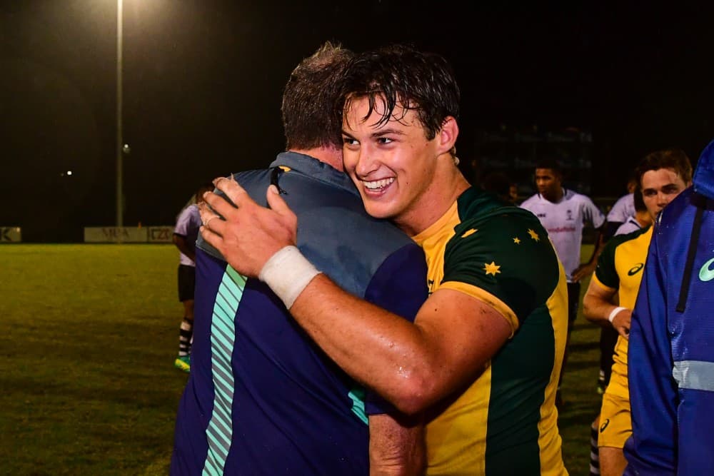 Junior Wallabies scrumhalf Michael McDonald embraces coach jason Gilmore after Australia's win over Fiji. Photo: RUGBY.com.au/Stuart Walmsley