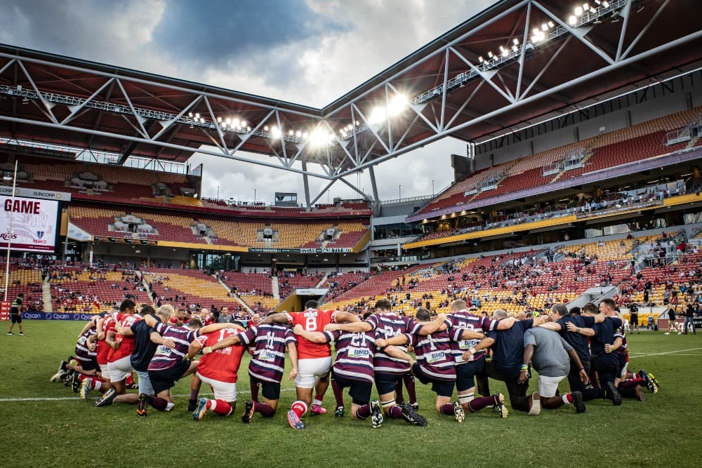 For Tonga - A powerful circle of solidarity for Tonga's recovery effort from the Tongan Invitational XV and Vintage Reds after their charity match. Photo: Brendan Hertel, QRU Media