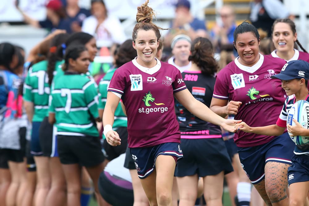 Lori Cramer leads out the Queensland women. Photo: Getty Images