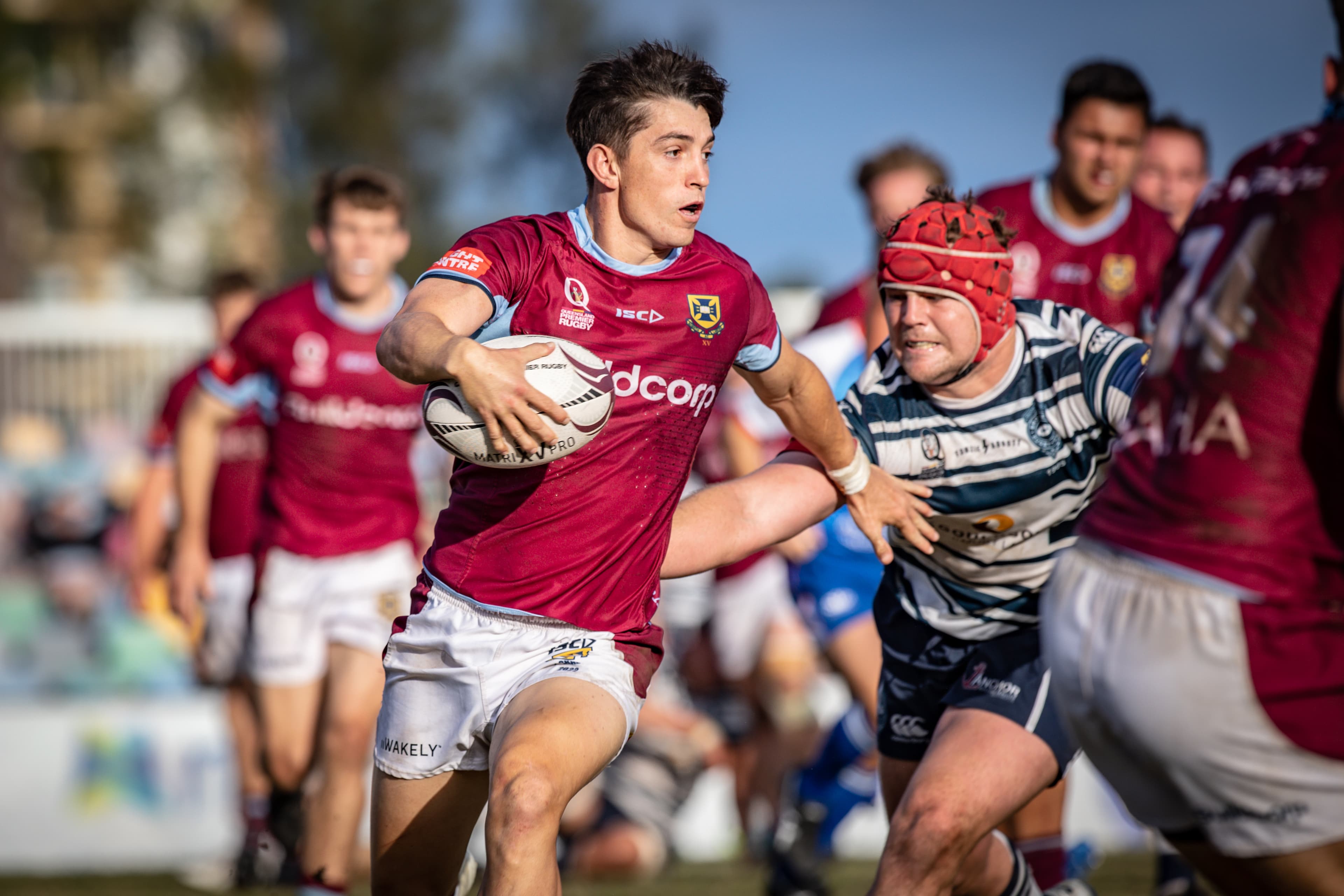 University fullback Jock Campbell struggles to evade the clutches of Wallaby squad teammate Harry Wilson. Photo: Brendan Hertel, QRU Media